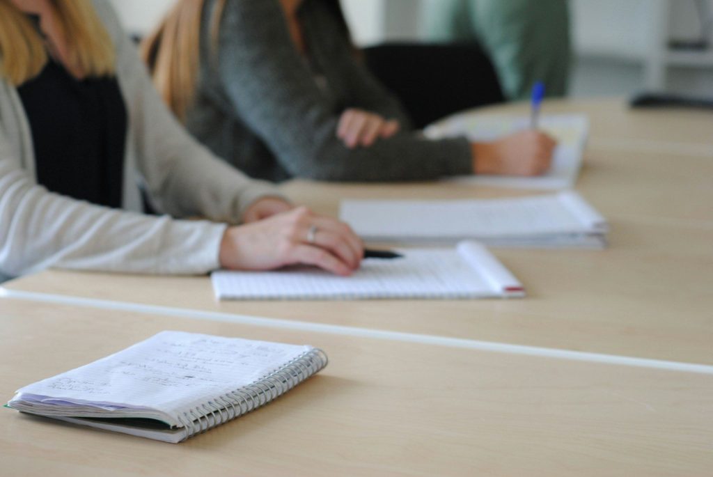 a person writing on a piece of paper